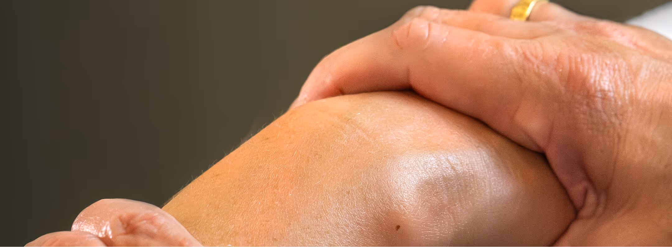 Close-up of physical therapist massaging a bent knee in a physical therapy clinic in san francisco, ca