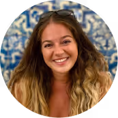 a woman, Dalma Szucs, with long hair and sunglasses smiling