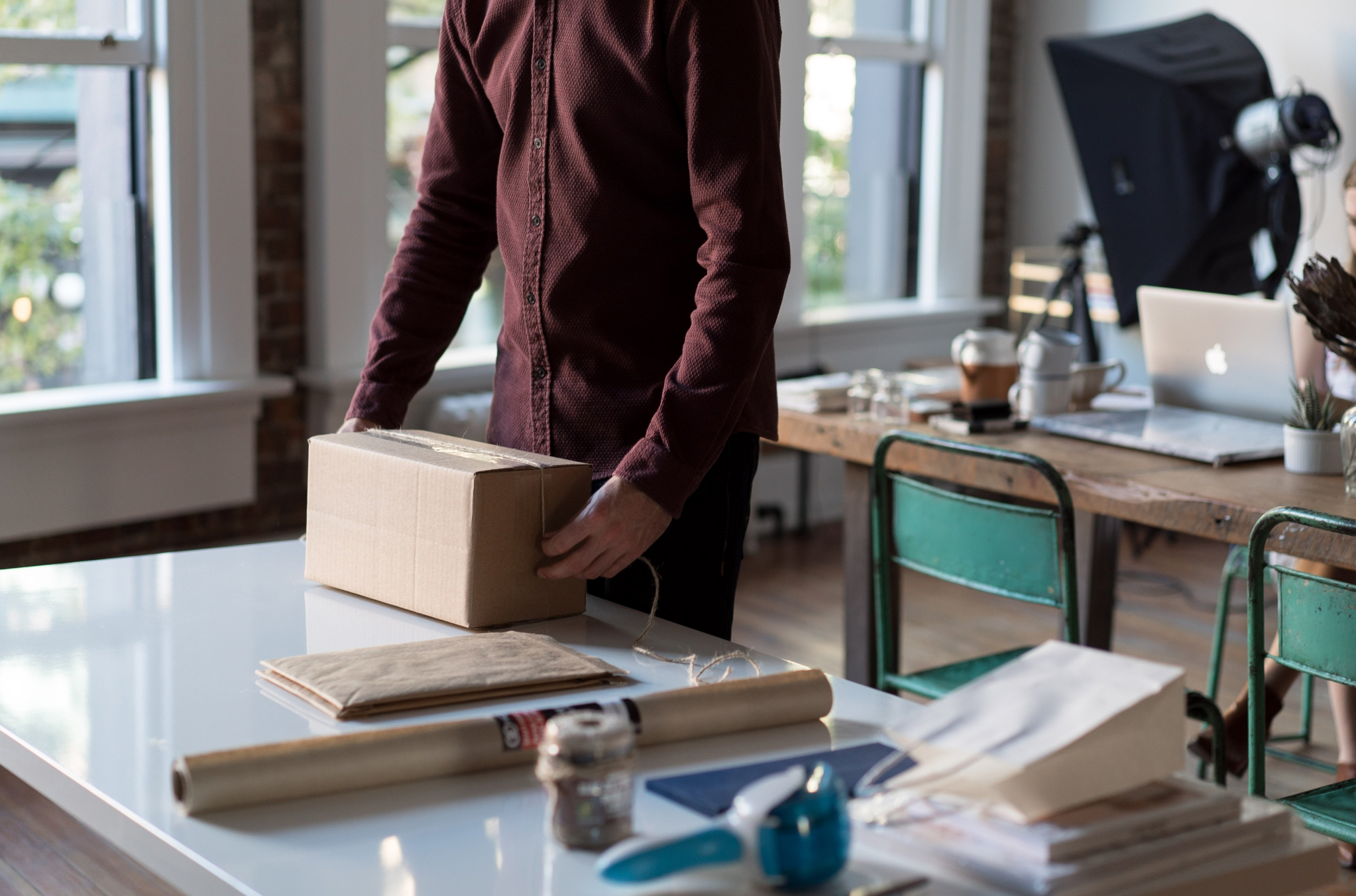 A man packing a box to ship out to a customer from his small D2C business
