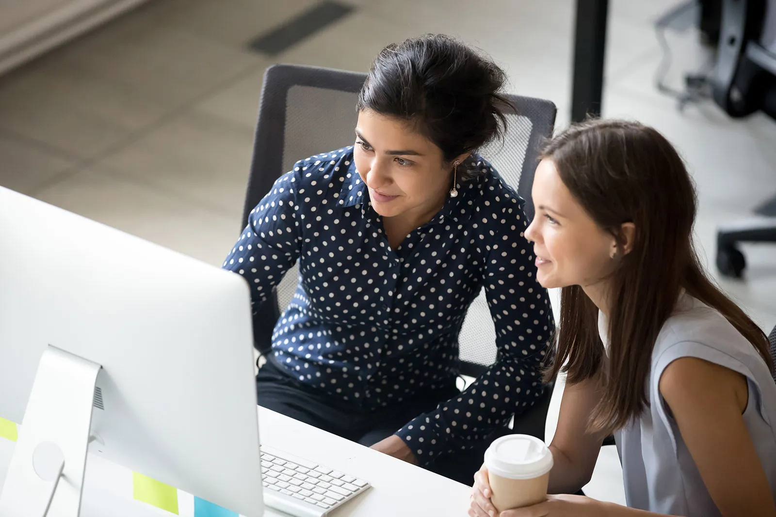 Two people meeting at computer