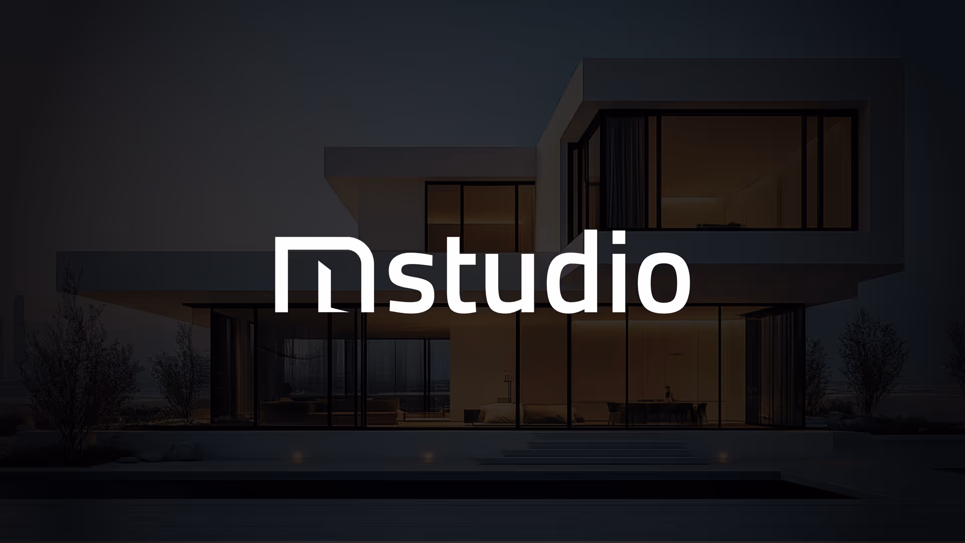 Modern two-story house with large glass windows illuminated from inside at dusk, overlayed with stylized text reading 'studio'.