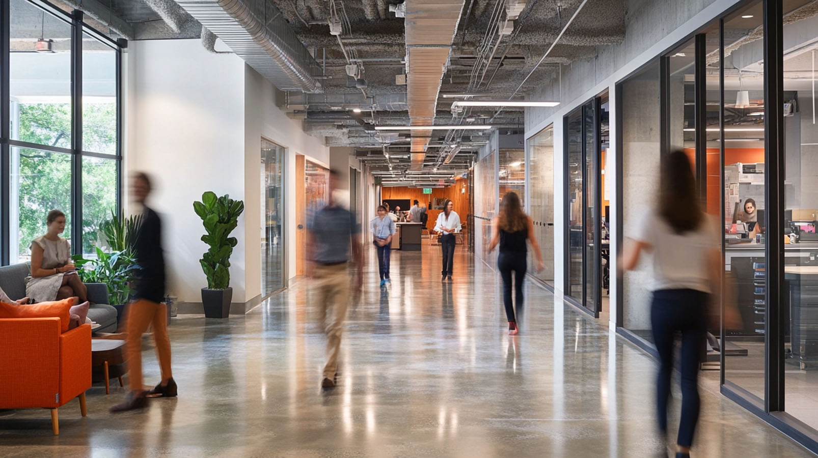 A group of people walking down a long hallway.