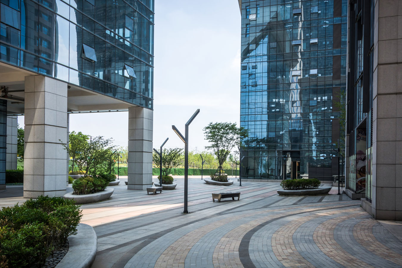 A large building with a lot of windows and plants.