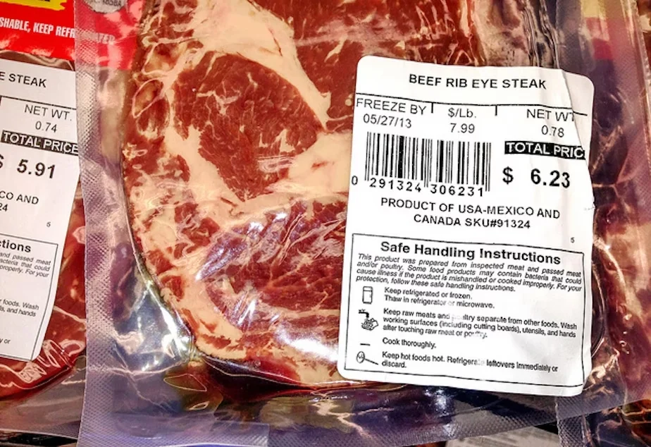 Vacuum-sealed beef rib eye steak package with label showing price $6.23, weight 0.78 lbs, freeze-by date 05/27/13, and safe handling instructions.