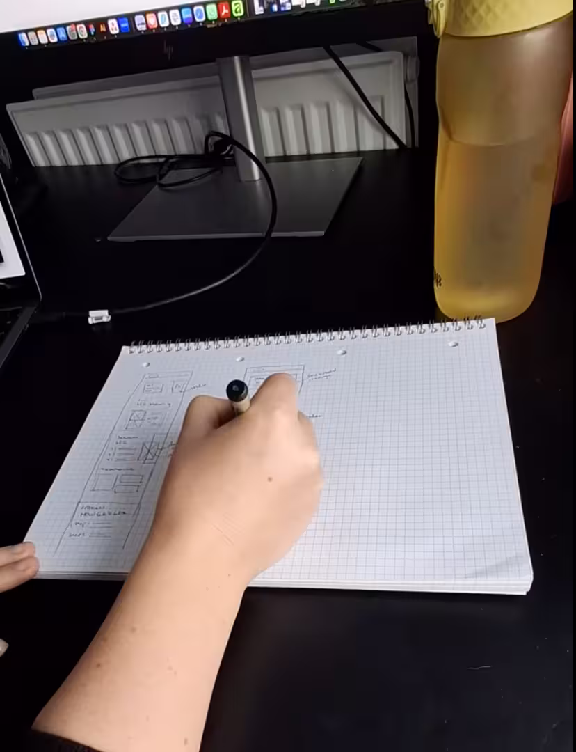 Rachel wireframing the layout of the new website using a pencil and paper.