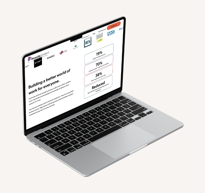 Laptop showing the new Diversity Scotland website. The heading "Building a better world of work for everyone" appears in dark text on the left. To the right, individual statistics are displayed with bright coloured borders