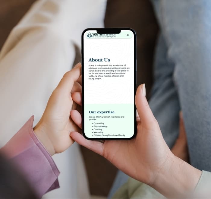 Two hands holding a mobile showing the About Us page. Dark text on a light background introduces the page, below, an "our expertise" section is on a mint-green background