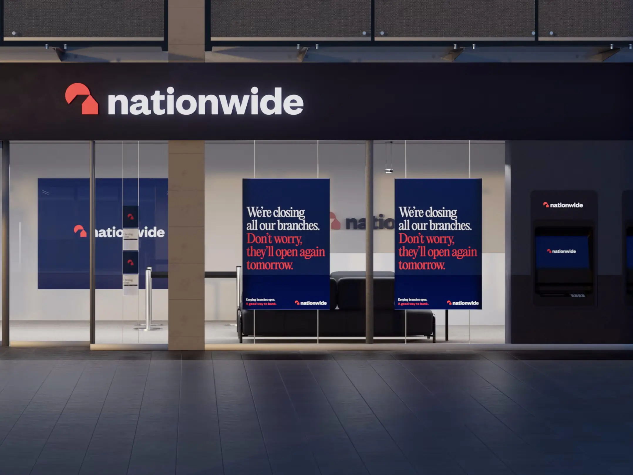 Nationwide bank storefront at night with signs stating branch closures but reassurance they will reopen tomorrow.