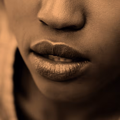Close-up of a person's lips and lower face, showing a neutral expression.