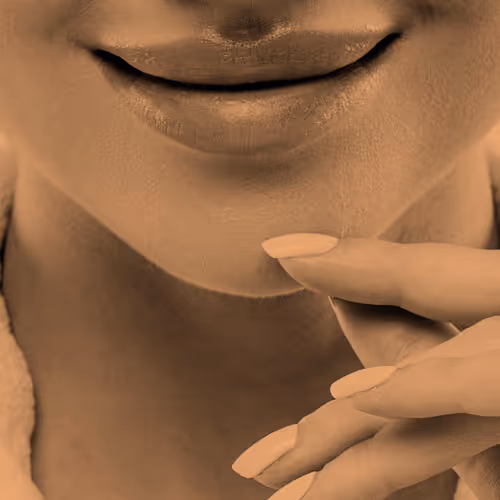 Close-up of a person's relaxed smile and hand with neatly manicured nails touching their chin.
