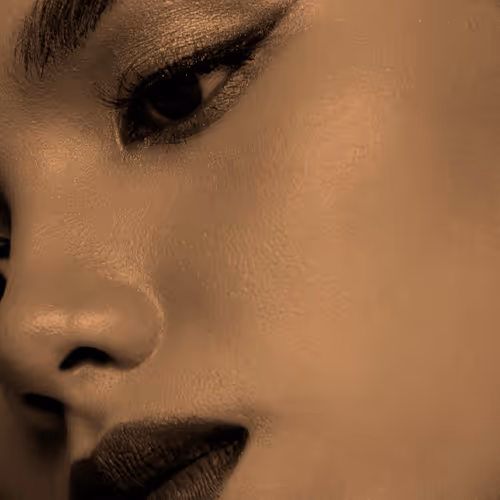 Close-up of a person's face, focusing on their eye and part of their nose and lips.