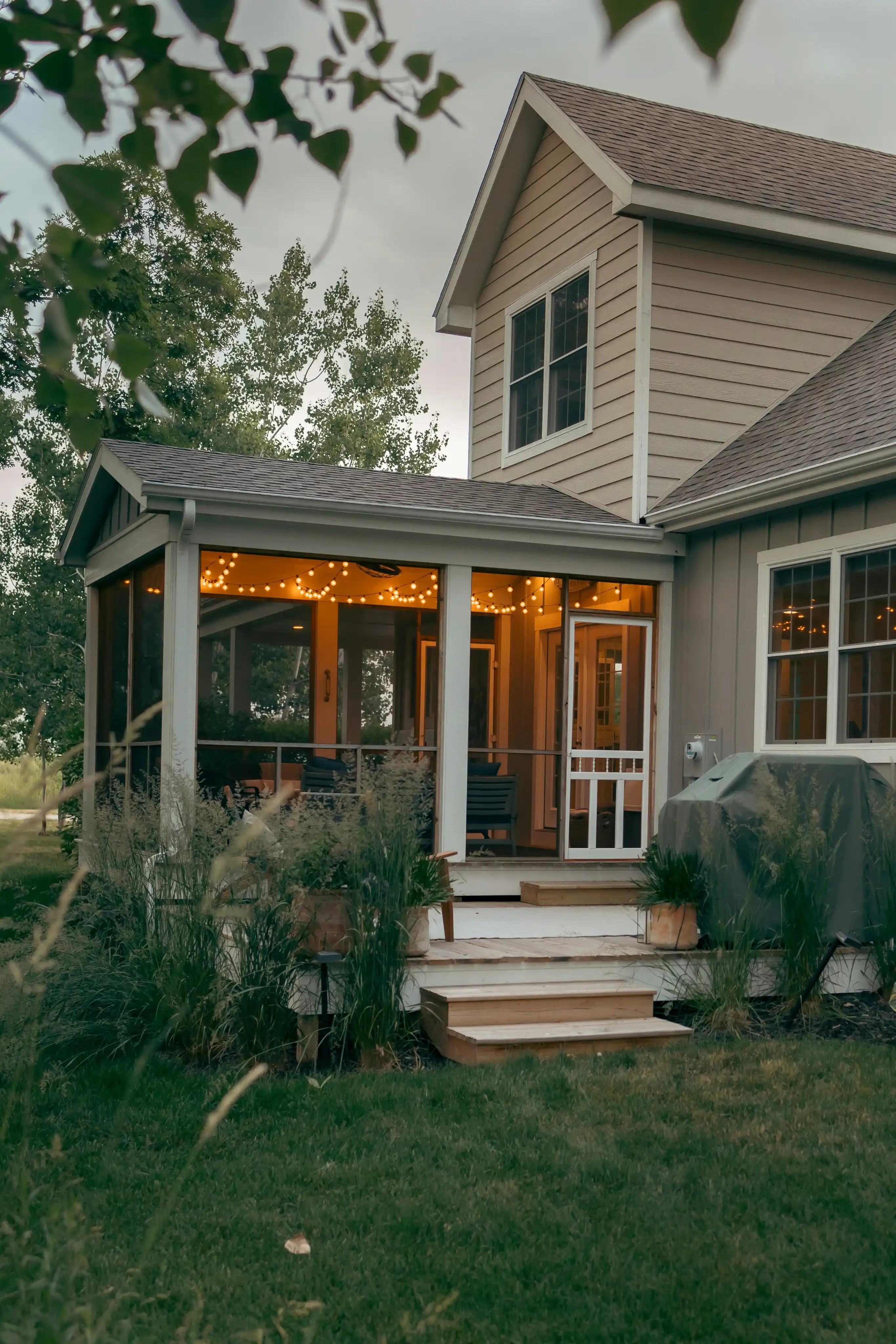 Side view image of a house with a lot grasses around it.