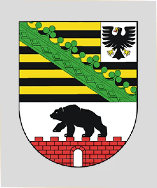 Wappen der Stadt Dessau mit Bär auf roter Mauer, schwarzem Adler und schwarz-gelb-grünen Elementen