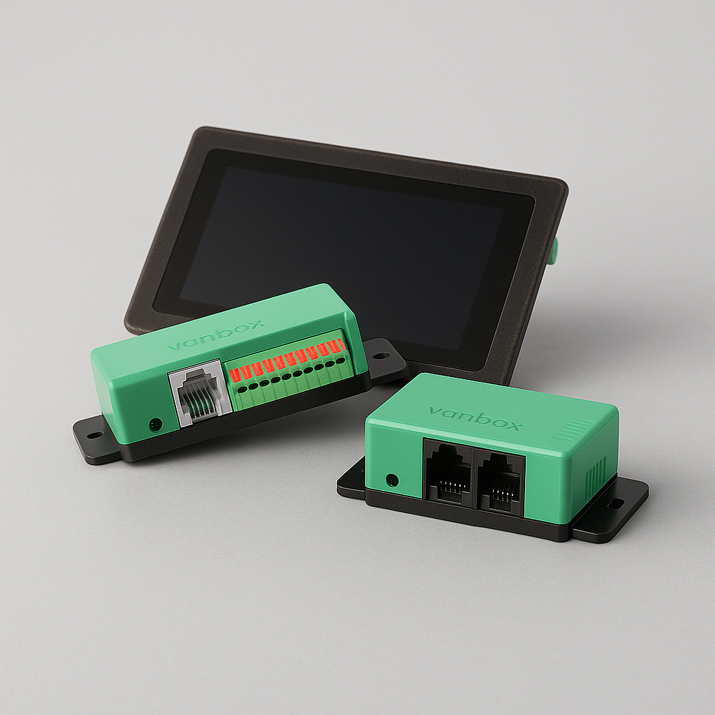 Two small green Vanbox electronic devices with ports and a black touchscreen in the background on a gray surface.