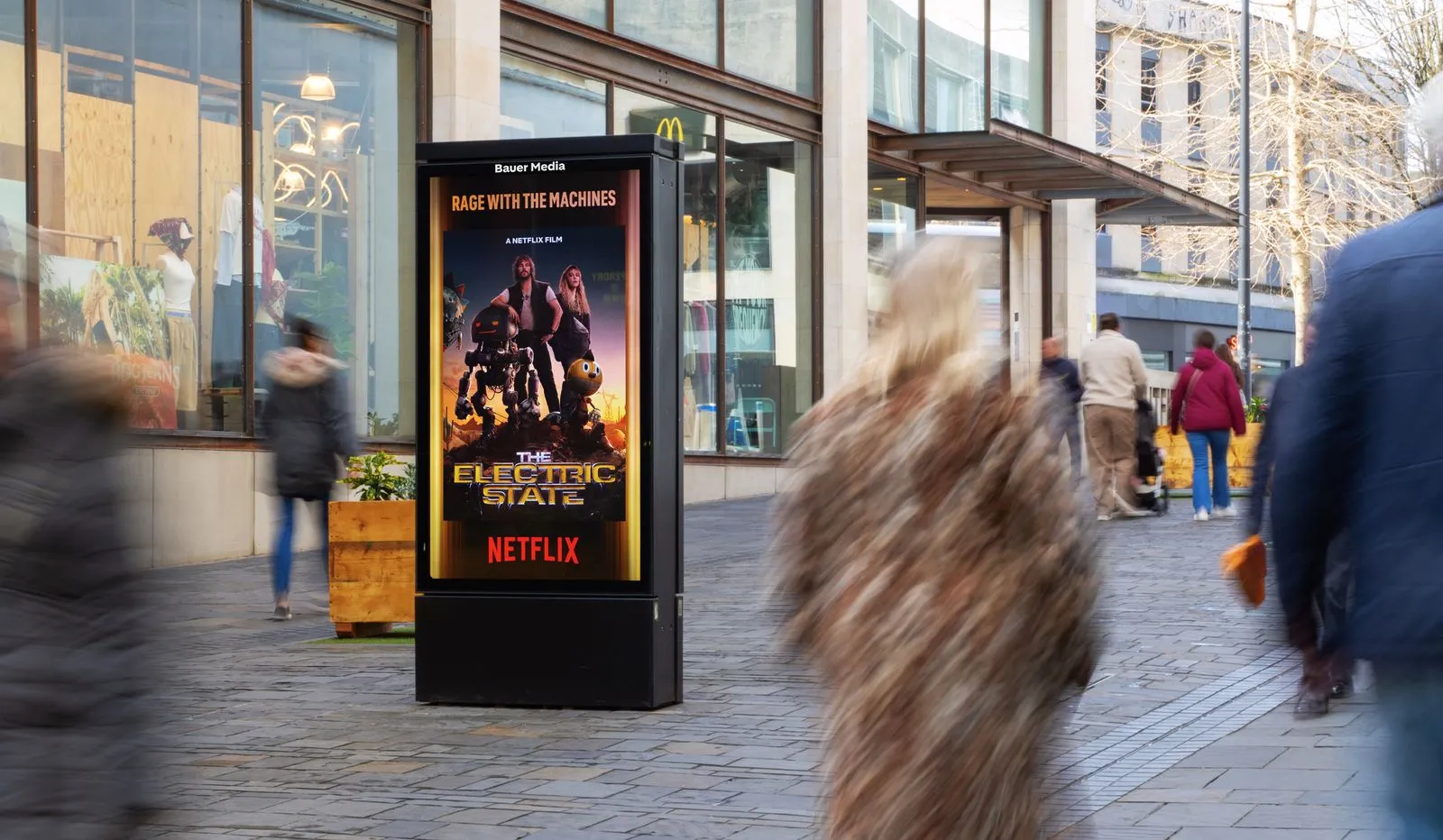 A digital screen on a high street with a Netflix campaign displayed