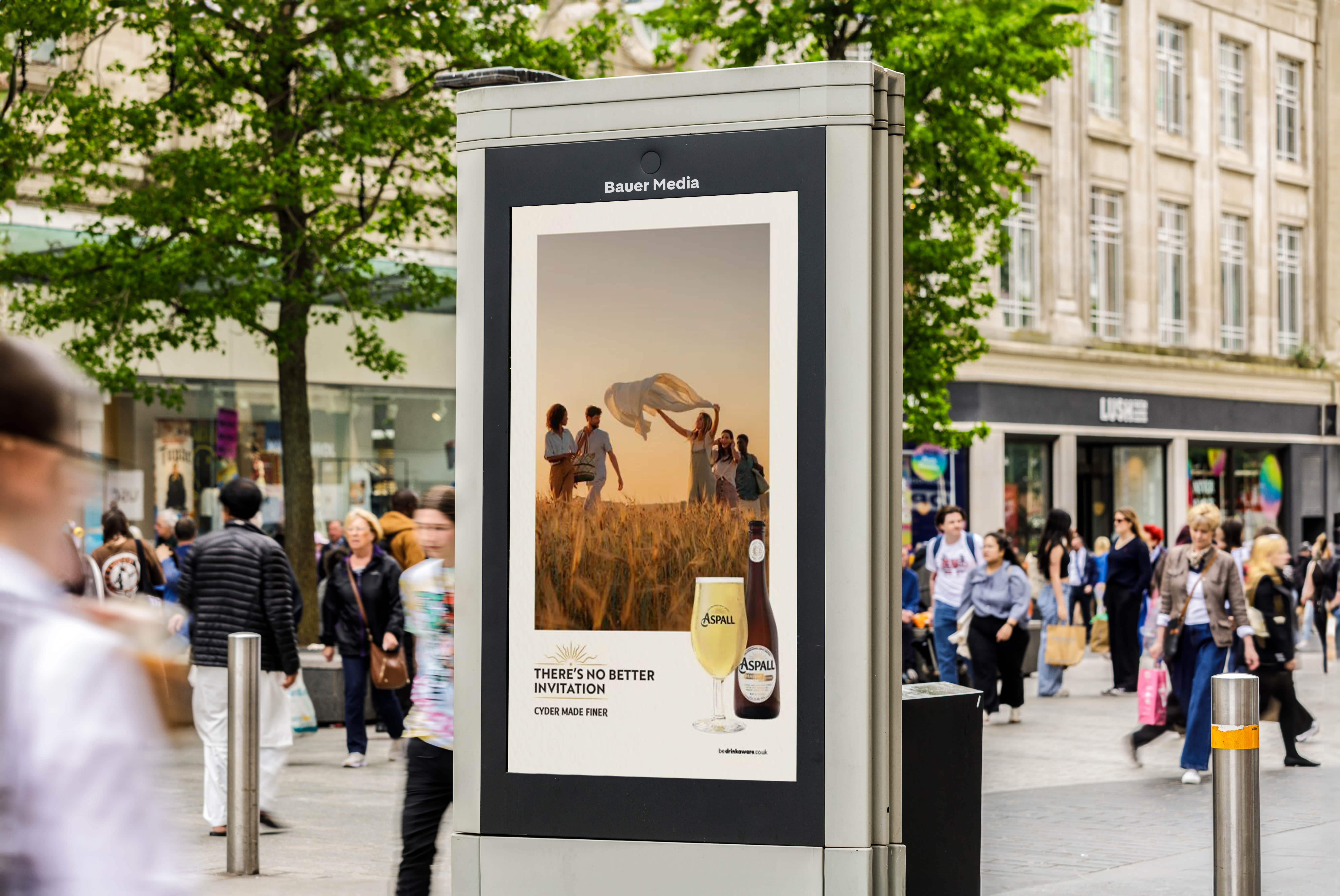 An Aspalls creative on a busy high street promoting their cider drink on a summers evening