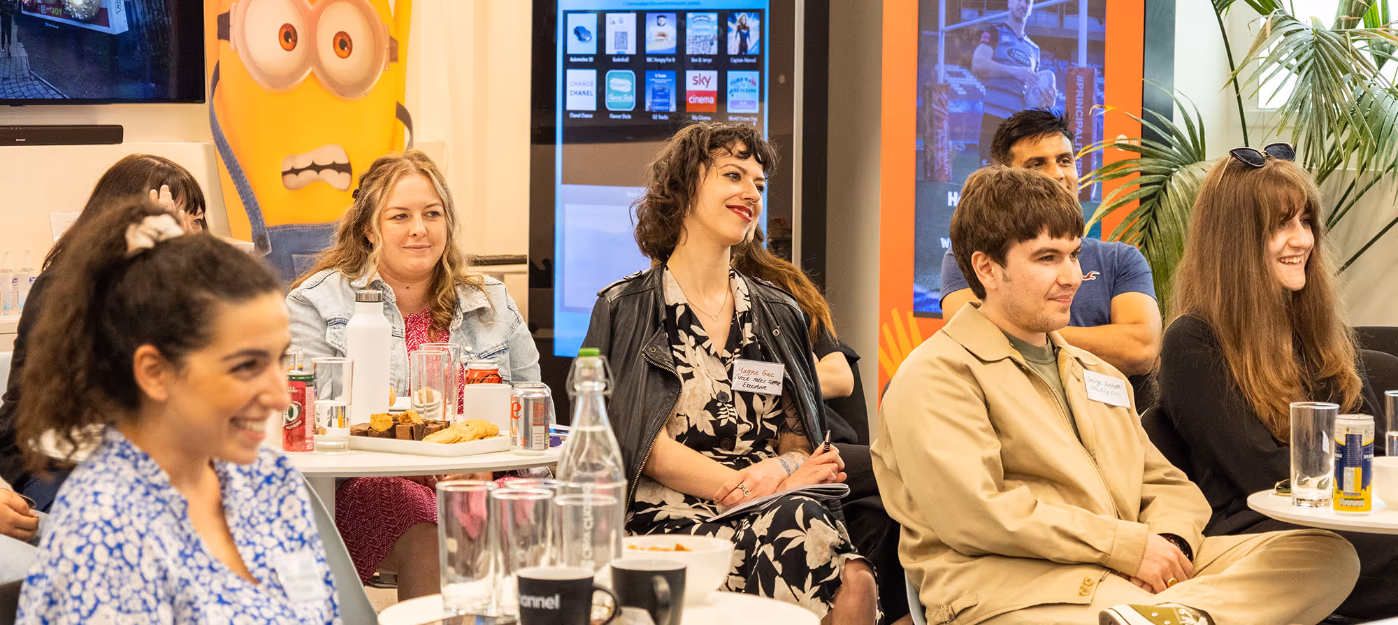 Group of people enjoying a presentation and smiling