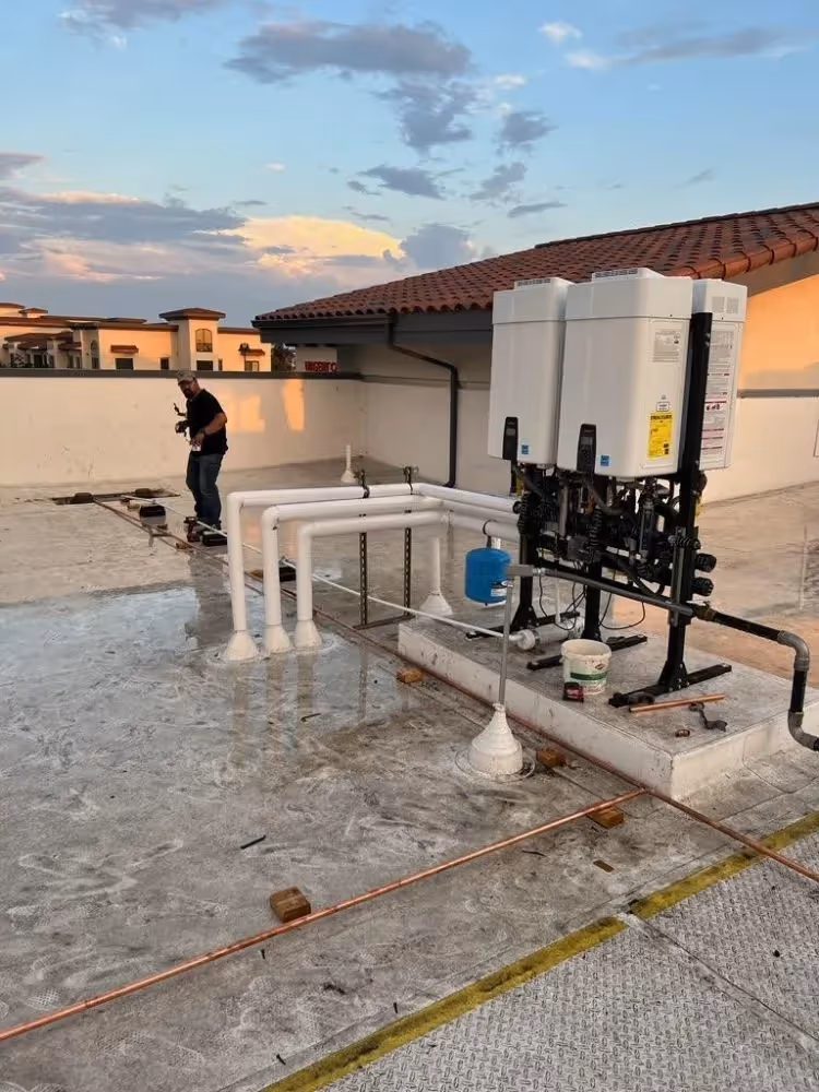 Water heater services on a rooftop in Murrieta, CA, with pipe installation.