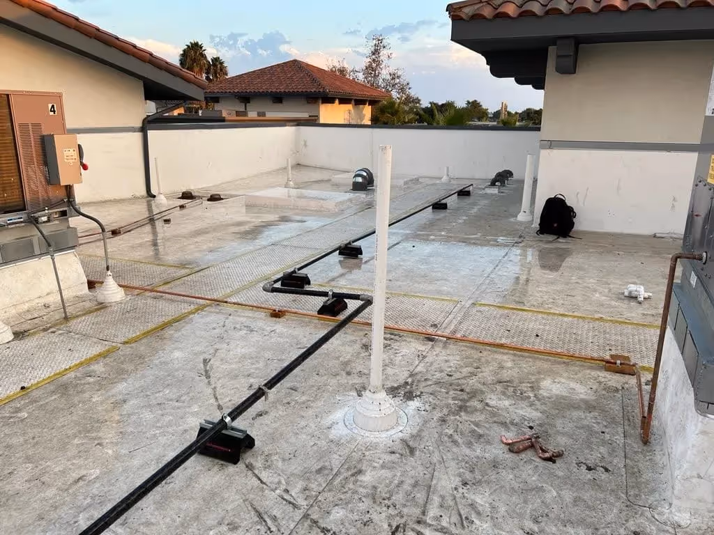Water line services on a rooftop in Murrieta, CA, with pipes being installed and set up.