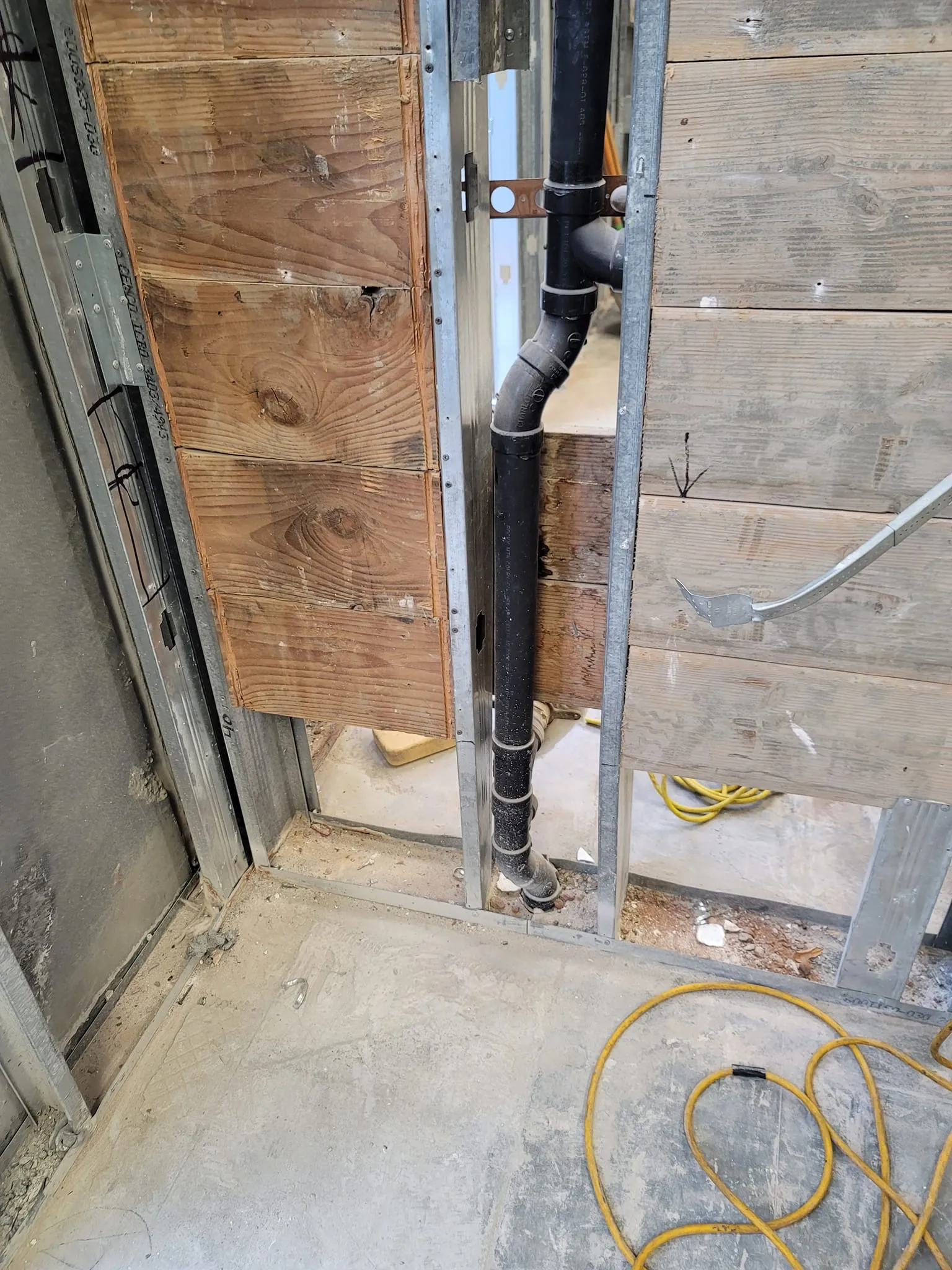 Exposed plumbing pipe inside a wall during plumbing repair in Murrieta, CA.