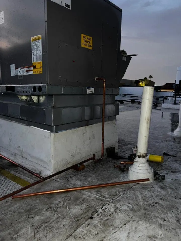 Plumbing installation in Menifee, CA, with pipes and HVAC systems being installed at a construction site.