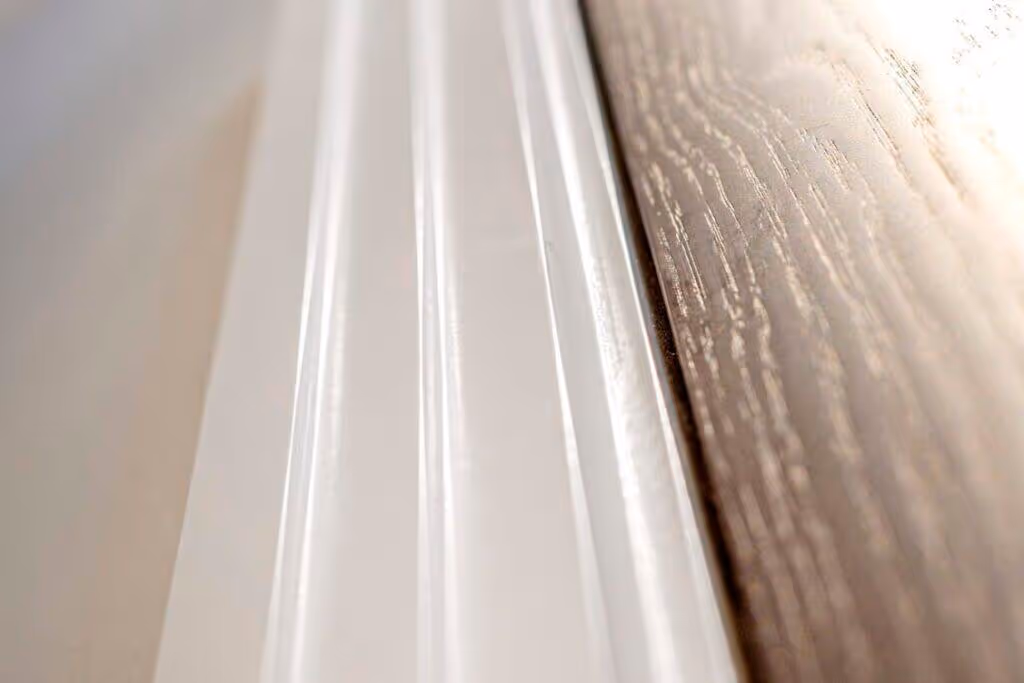 Close up of airless paint spraying on wood.