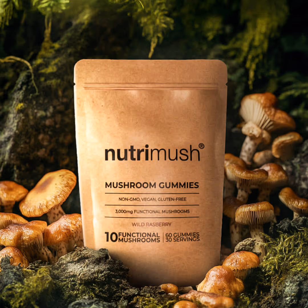 NutriMush mushroom gummies pouch surrounded by mushrooms and moss, labeled wild raspberry flavor with 10 functional mushrooms, 60 gummies, and 30 servings.
