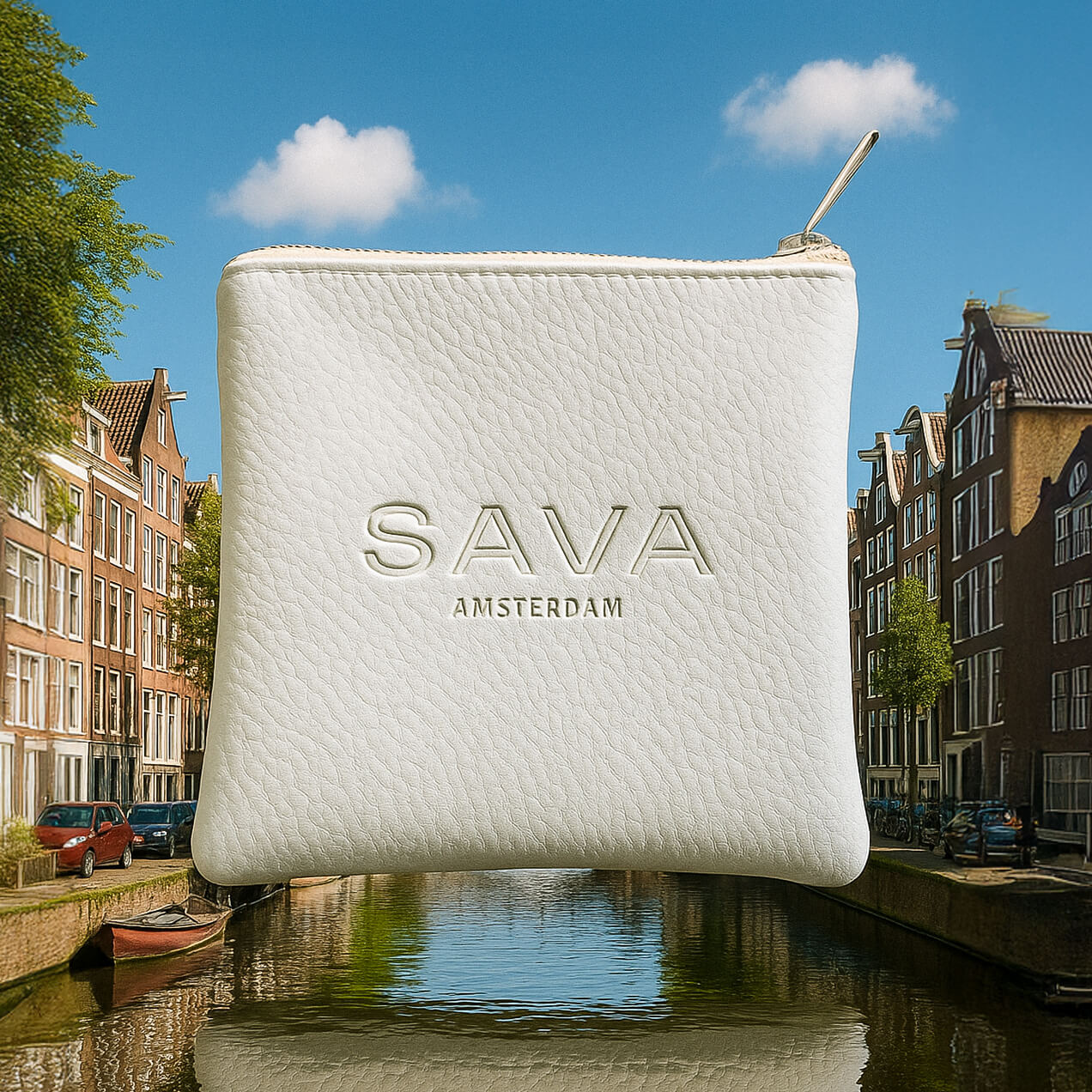 White leather pouch embossed with 'SAVA AMSTERDAM' floating over an Amsterdam canal with houses and boats.