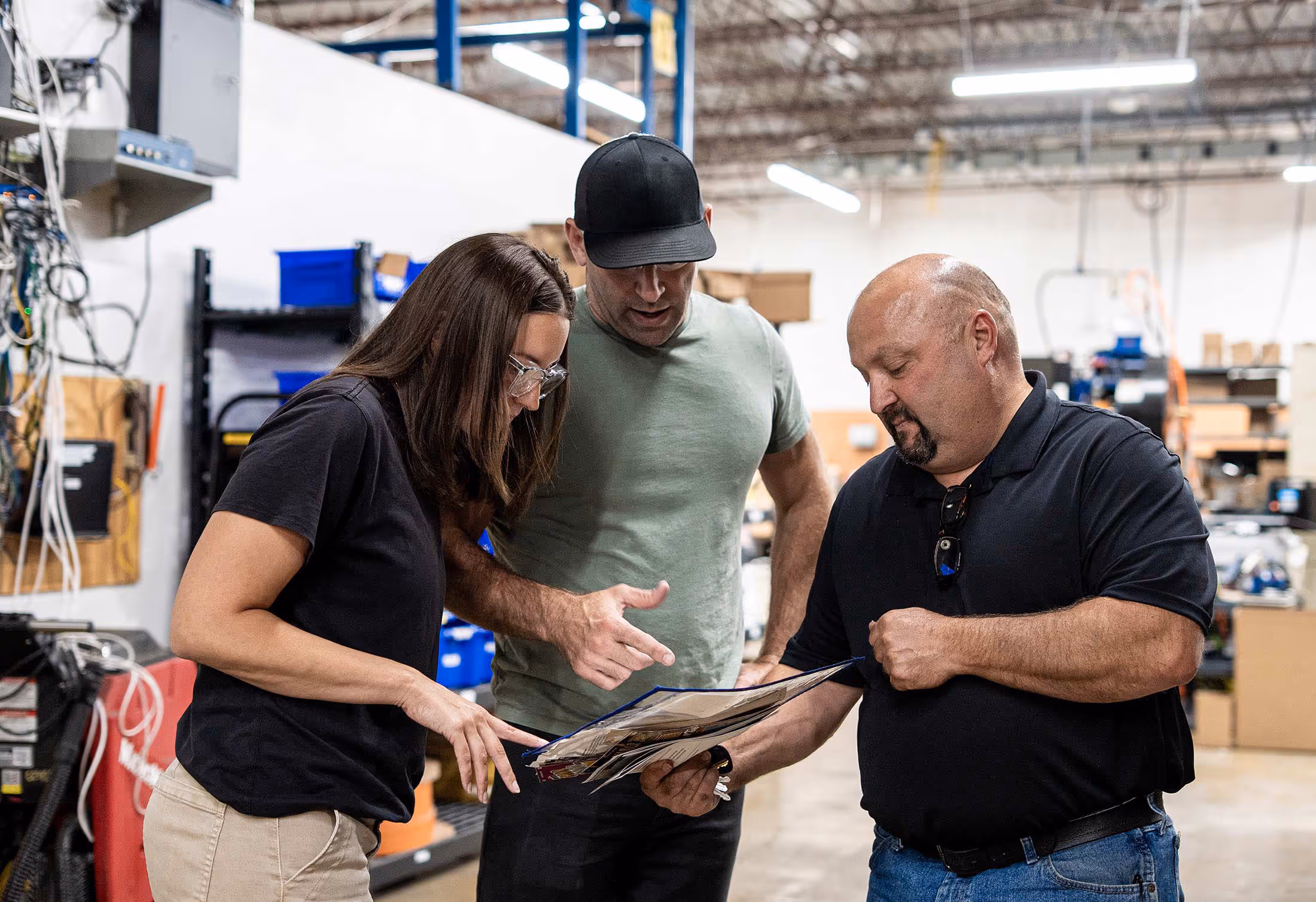 Insure employees looking at an order sheet in the shop