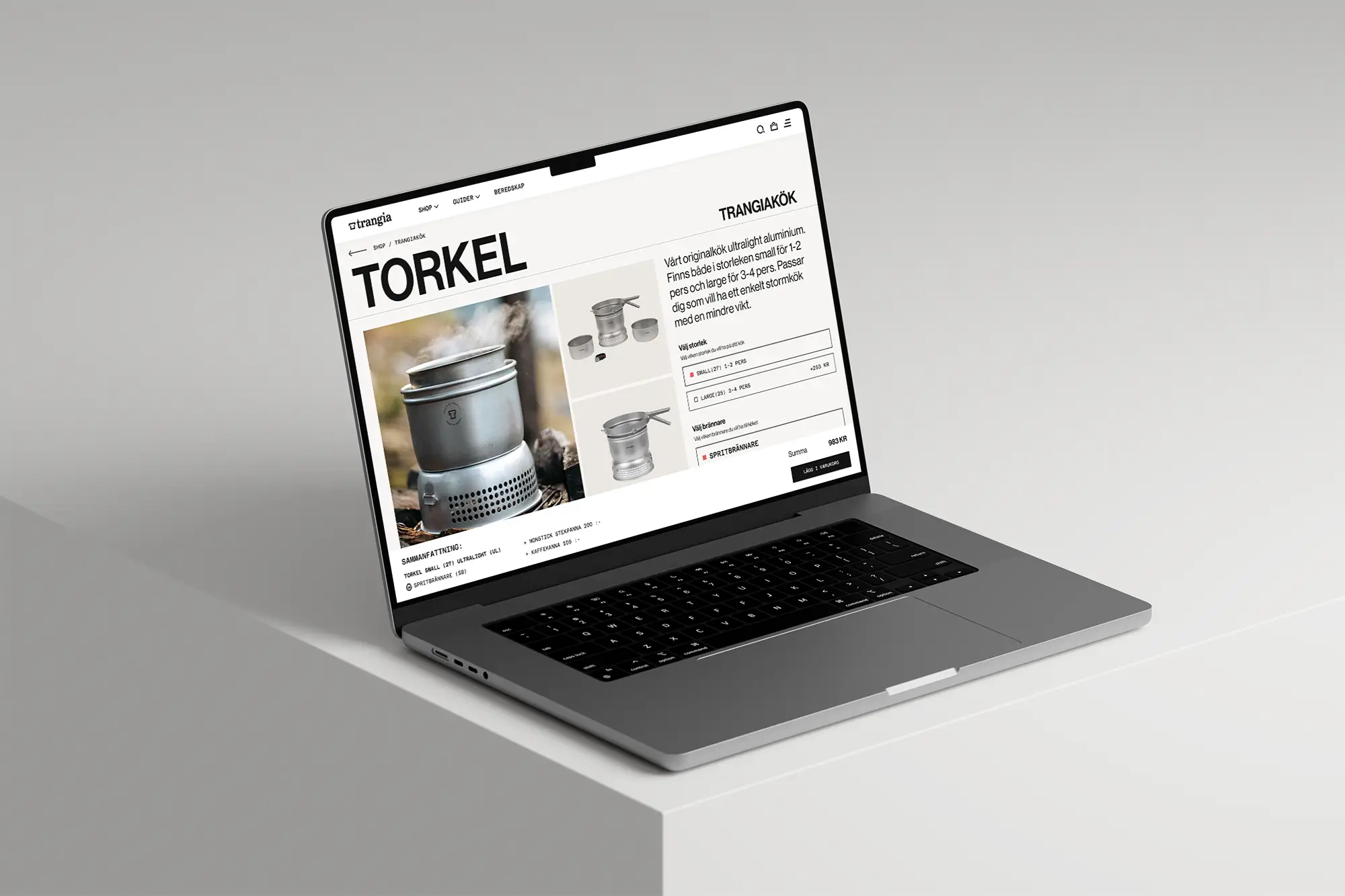 A laptop on a light gray surface displays a product page for a Torkel Trangia cooking set, showing product images, details, and an add-to-cart button on the screen.