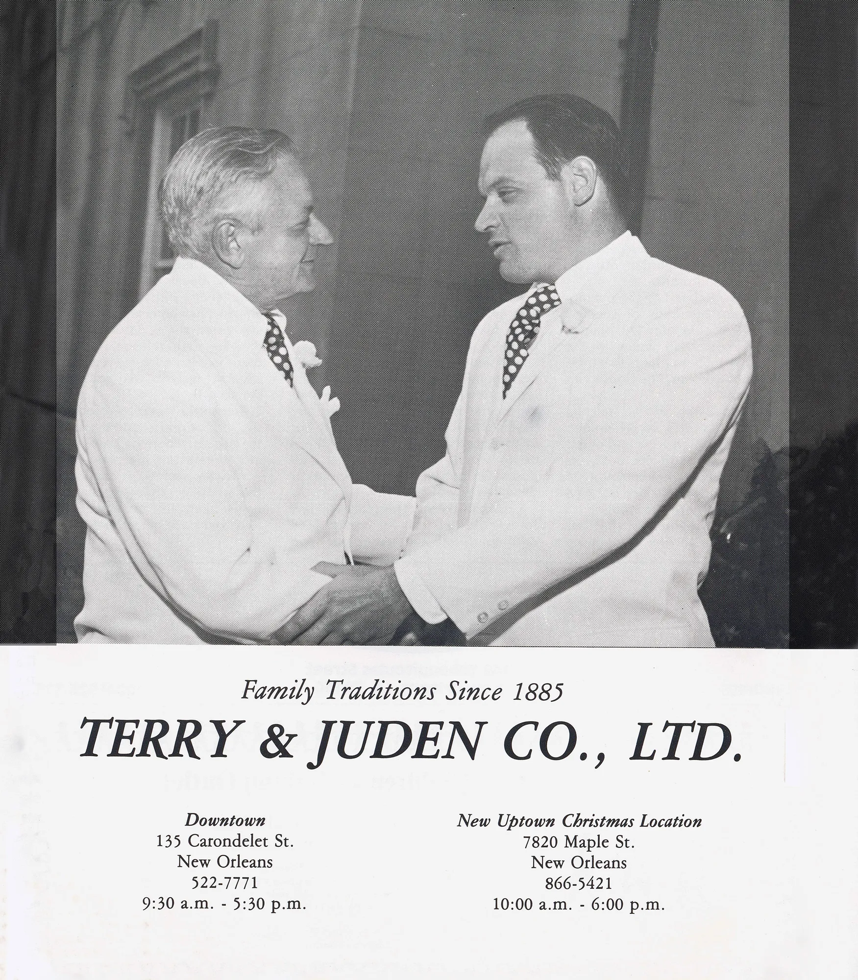 Two men in white suits shaking hands, vintage black and white photo with company text below.