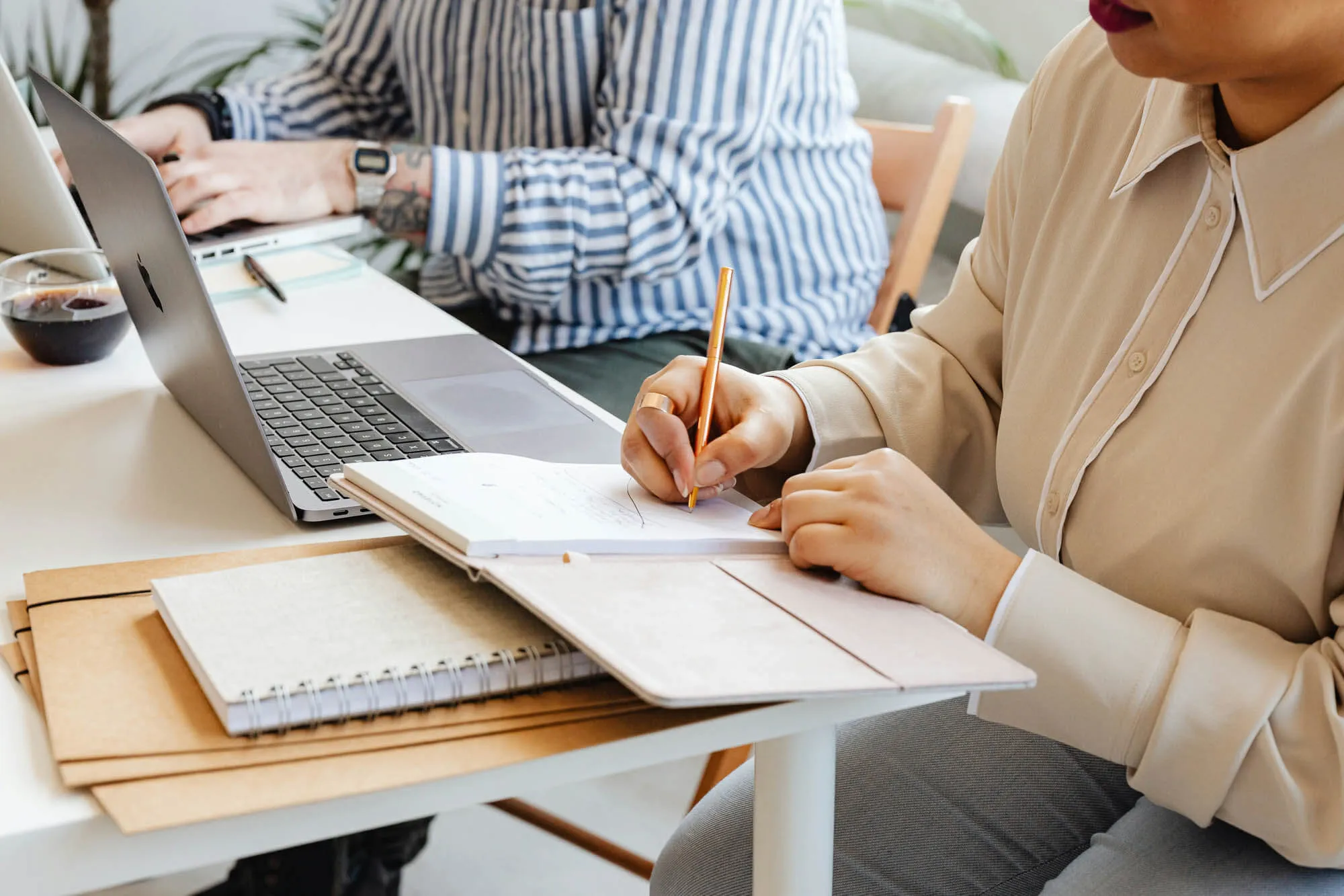 Two accountants working at a desk, preparing tax documents for clients.