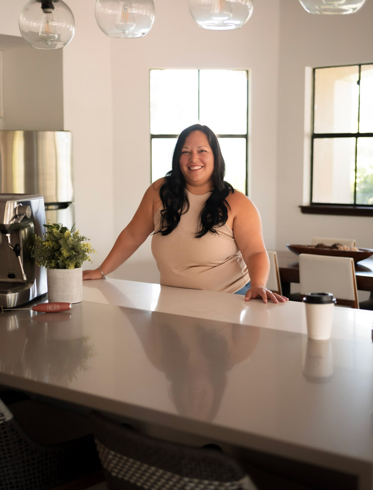 Sunkissed Brew owner smiling in a bright kitchen space during a brand photoshoot