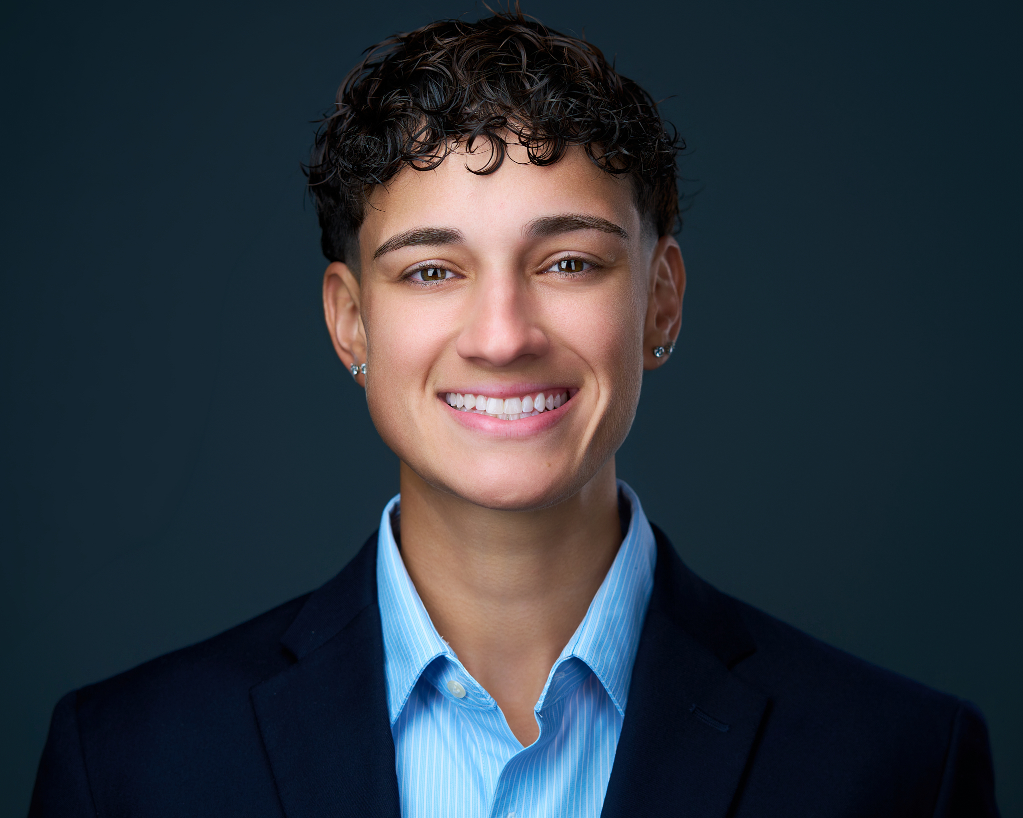 Corporate headshot of Cassady Quintana on a dark backdrop