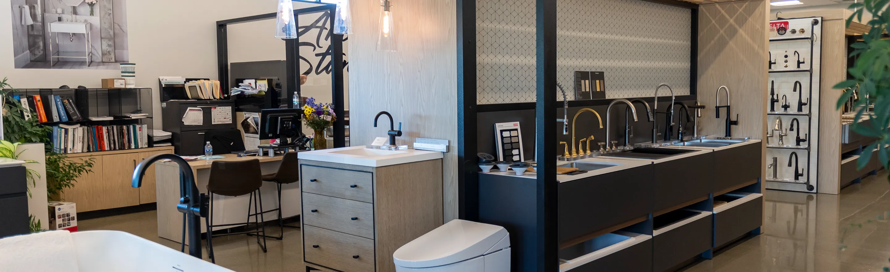 Modern showroom interior at The Water Closet Billings location, featuring sinks, faucets, and workspaces.