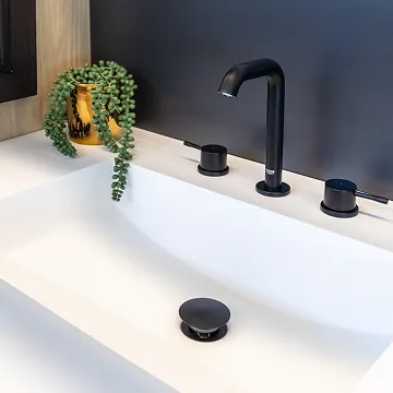 White countertop sink with matte black faucet and modern fixtures at The Water Closet showroom.