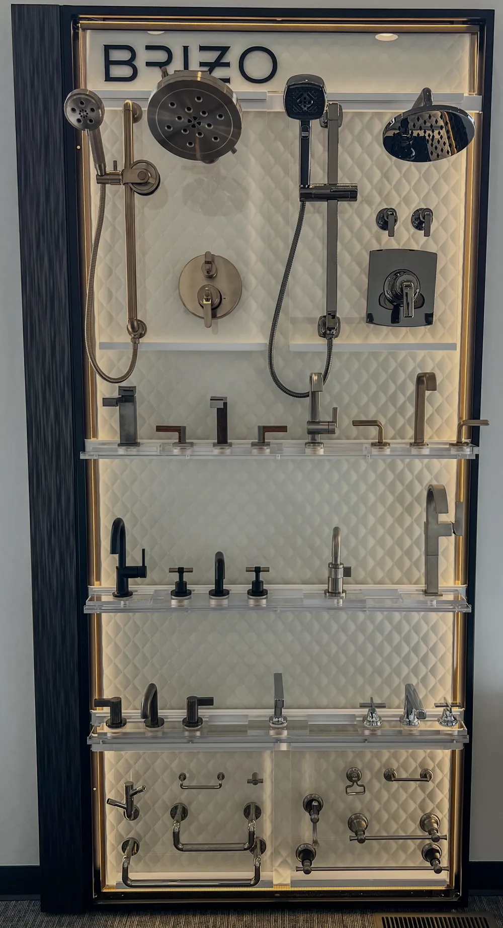 Tall bathroom fixture and hardware display wall in The Water Closet Bozeman showroom