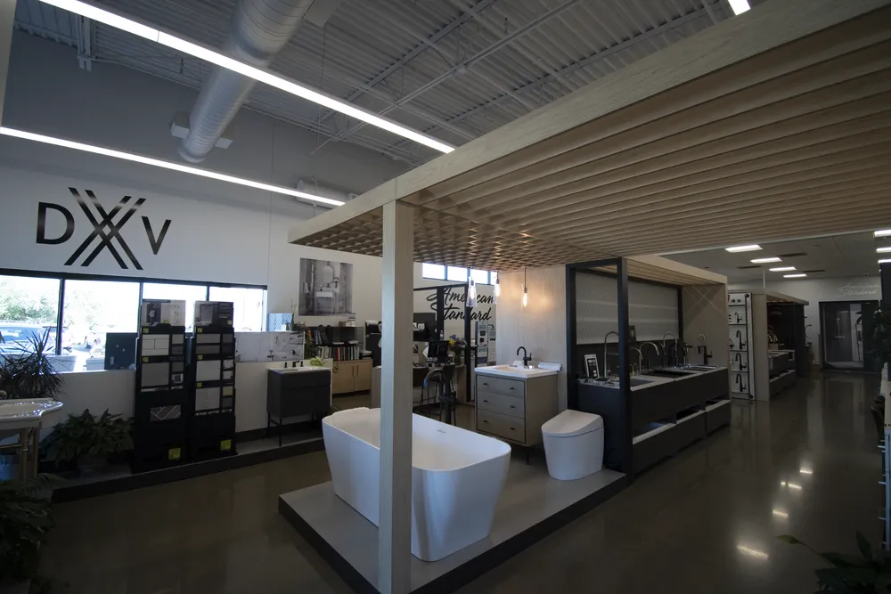 Wide interior view of The Water Closet Billings showroom with luxury bath displays