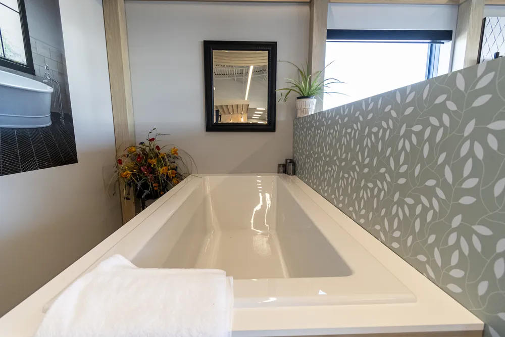 Bathtub showroom vignette with tiled wall in Billings location