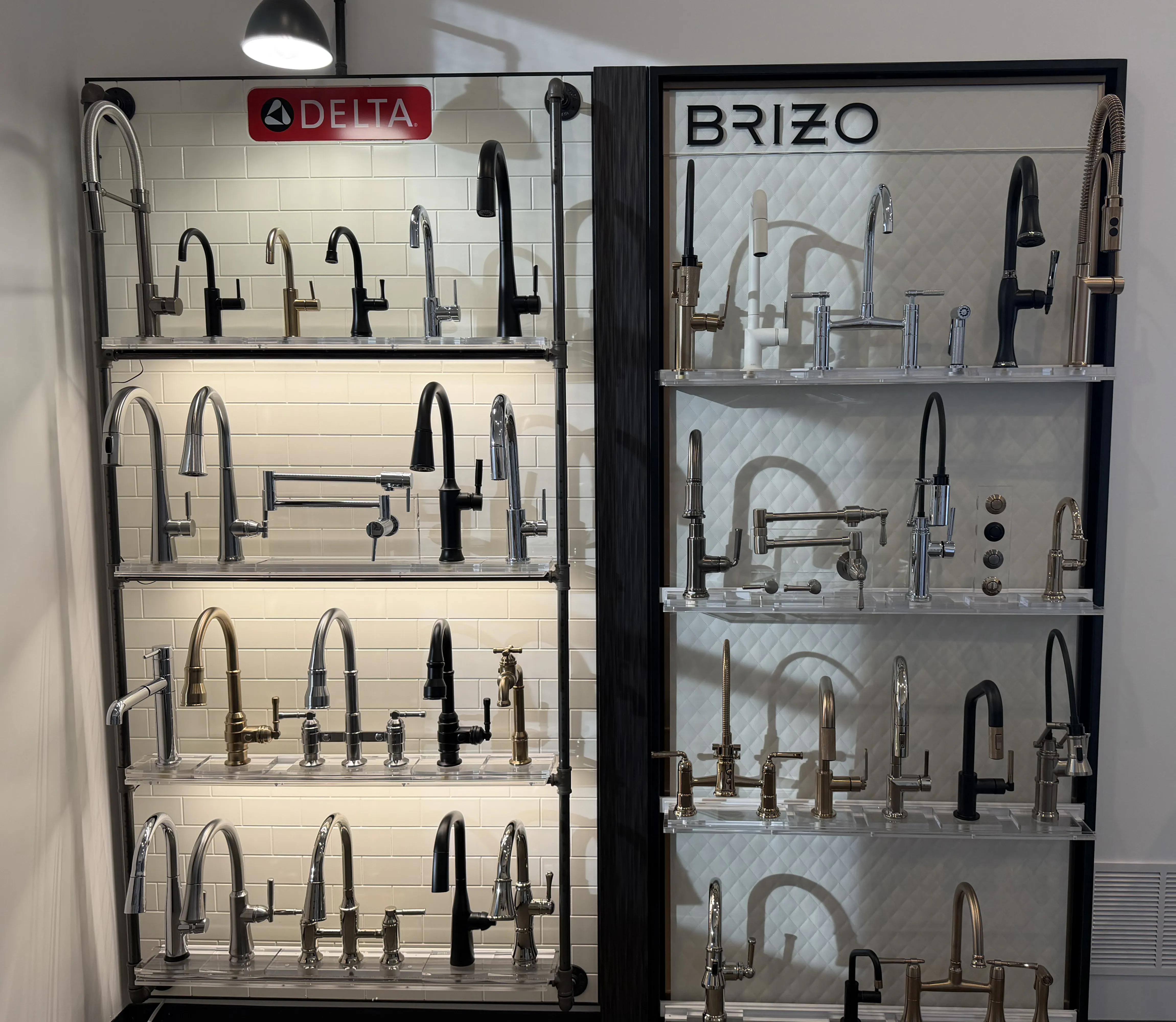 Fixture display wall with faucets and hardware in The Water Closet Bozeman showroom