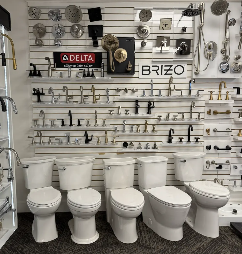 Row of modern toilet displays with fixture wall in The Water Closet Kalispell showroom