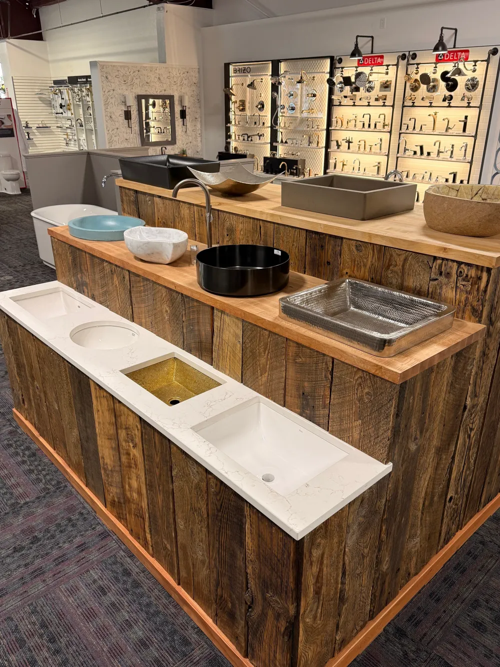 Bathroom showroom island with sink and faucet displays in Missoula