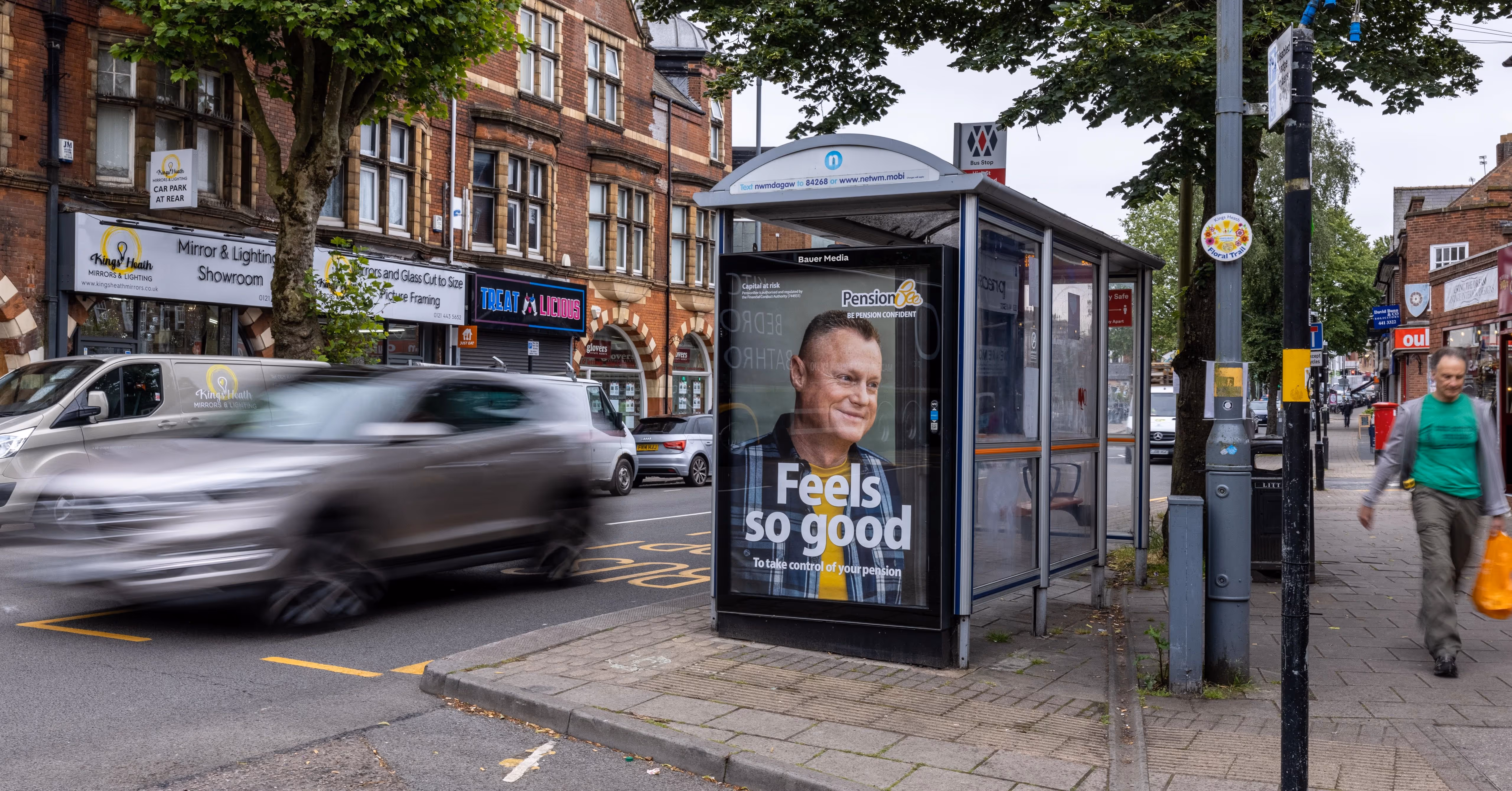 PensionBee's 'Feels so good' Adshel advertisement on a busy high street