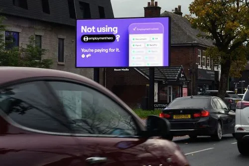 Employment Hero advertising on a digital Billboard Live with traffic driving past