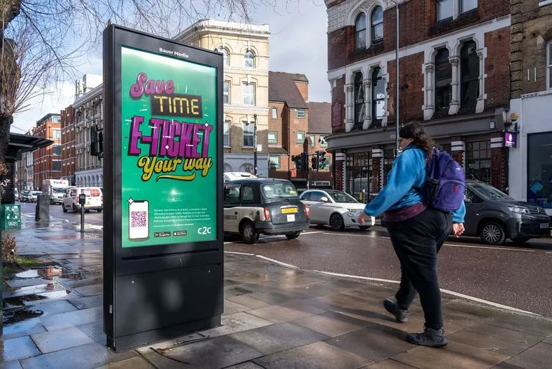 A standalone digital screen along a high street