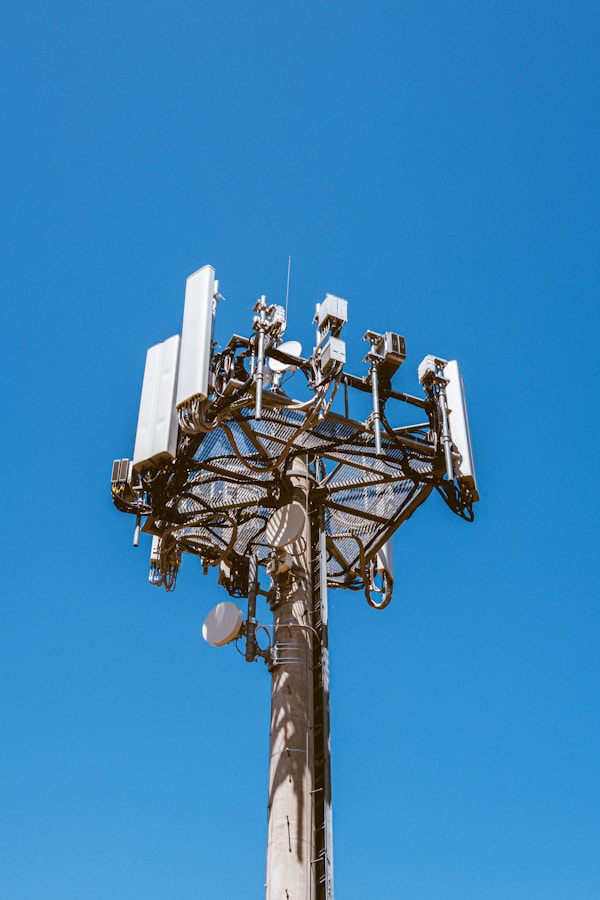 A telecom tower against a blue sky.