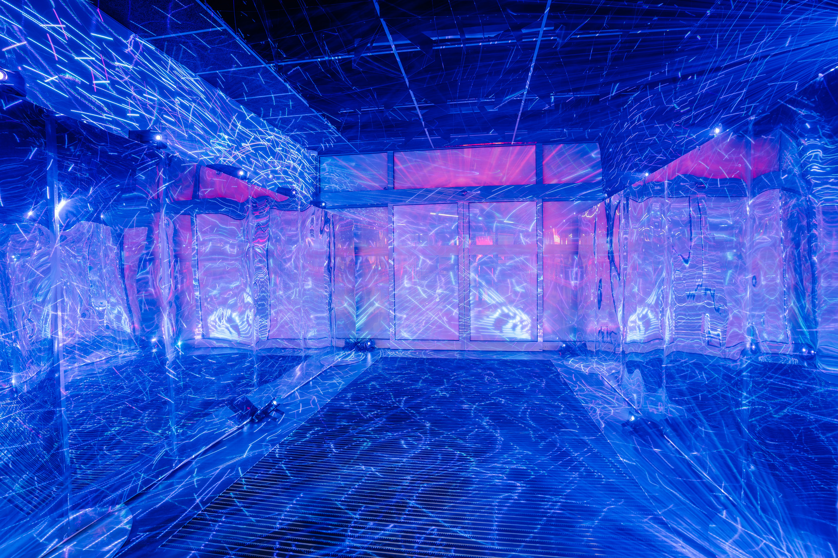Immersive mirrored installation lit with blue and pink neon for a brand activation