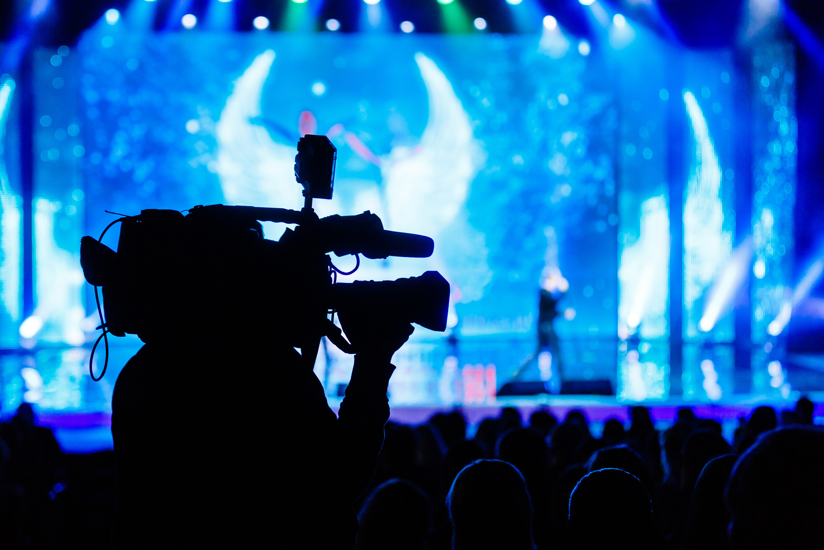 Camera operator capturing a live stage experience for digital content