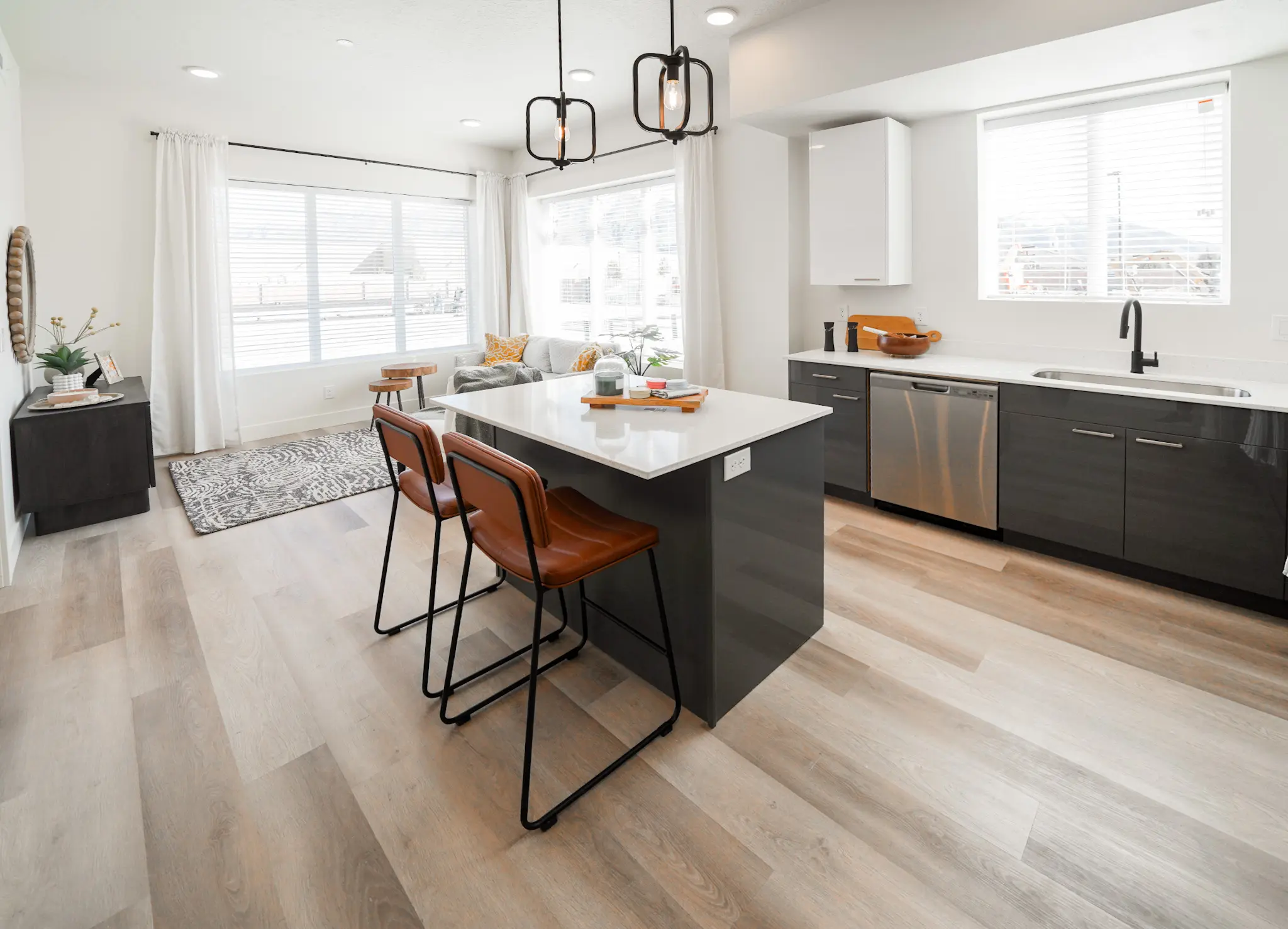 A kitchen island with a washer and sink in the background.