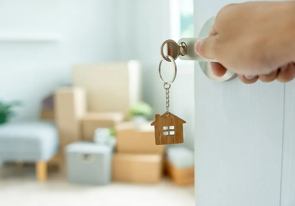 an open door with a key in the door handle opening into an apartment
